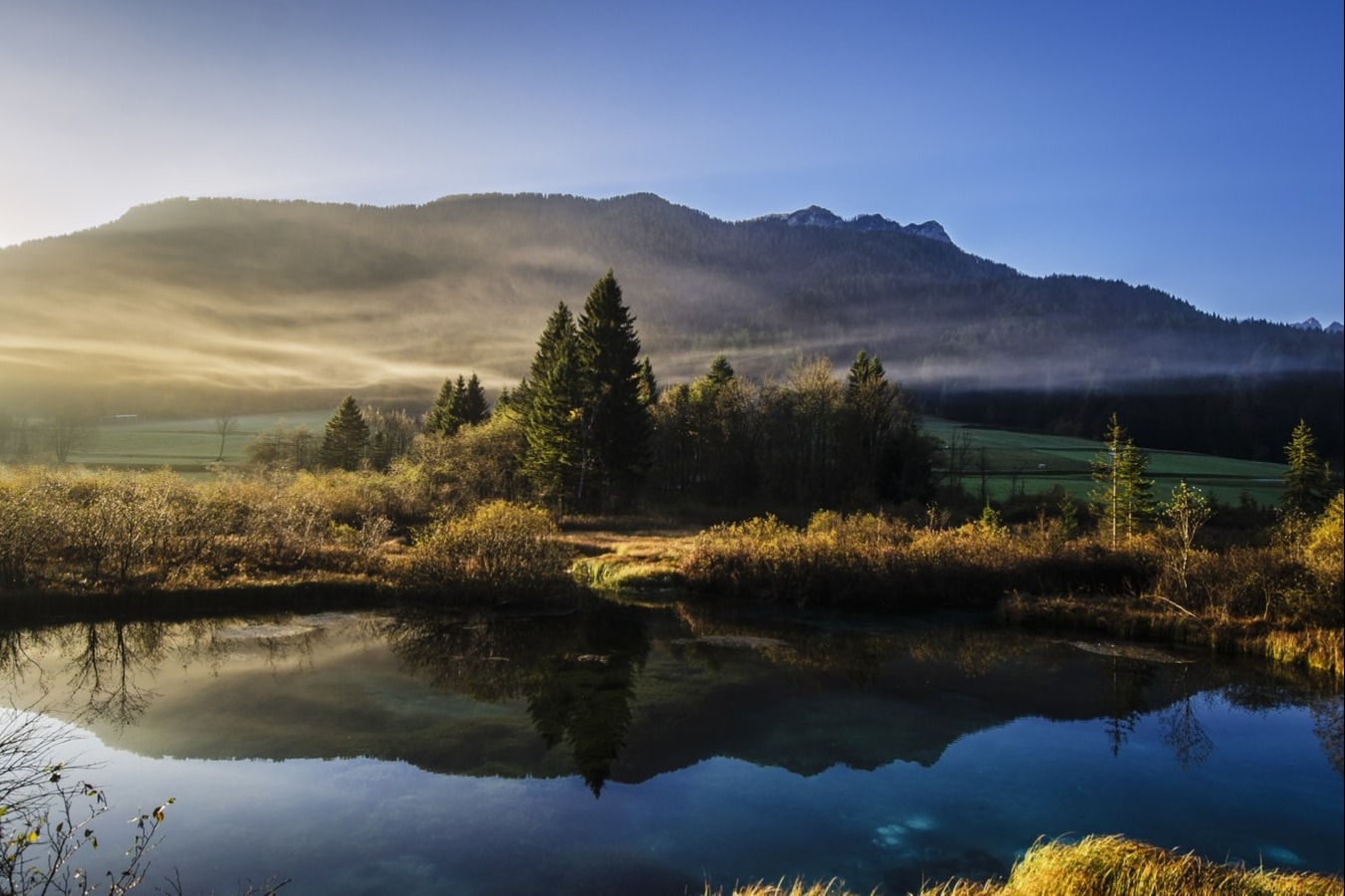 photo of mountain with lake and mist