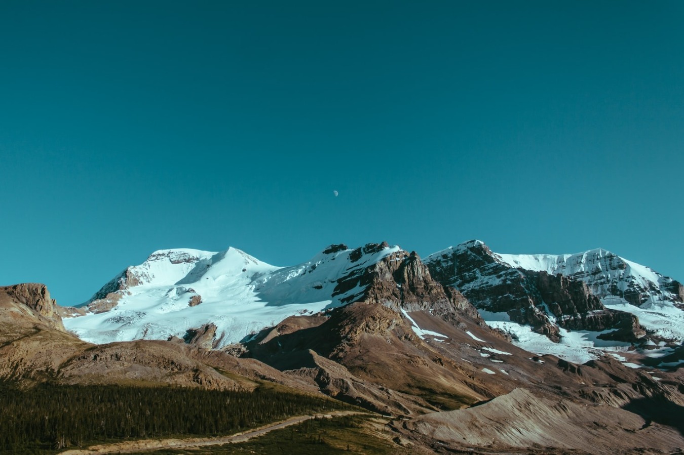 photo of mountain with blue sky and moon